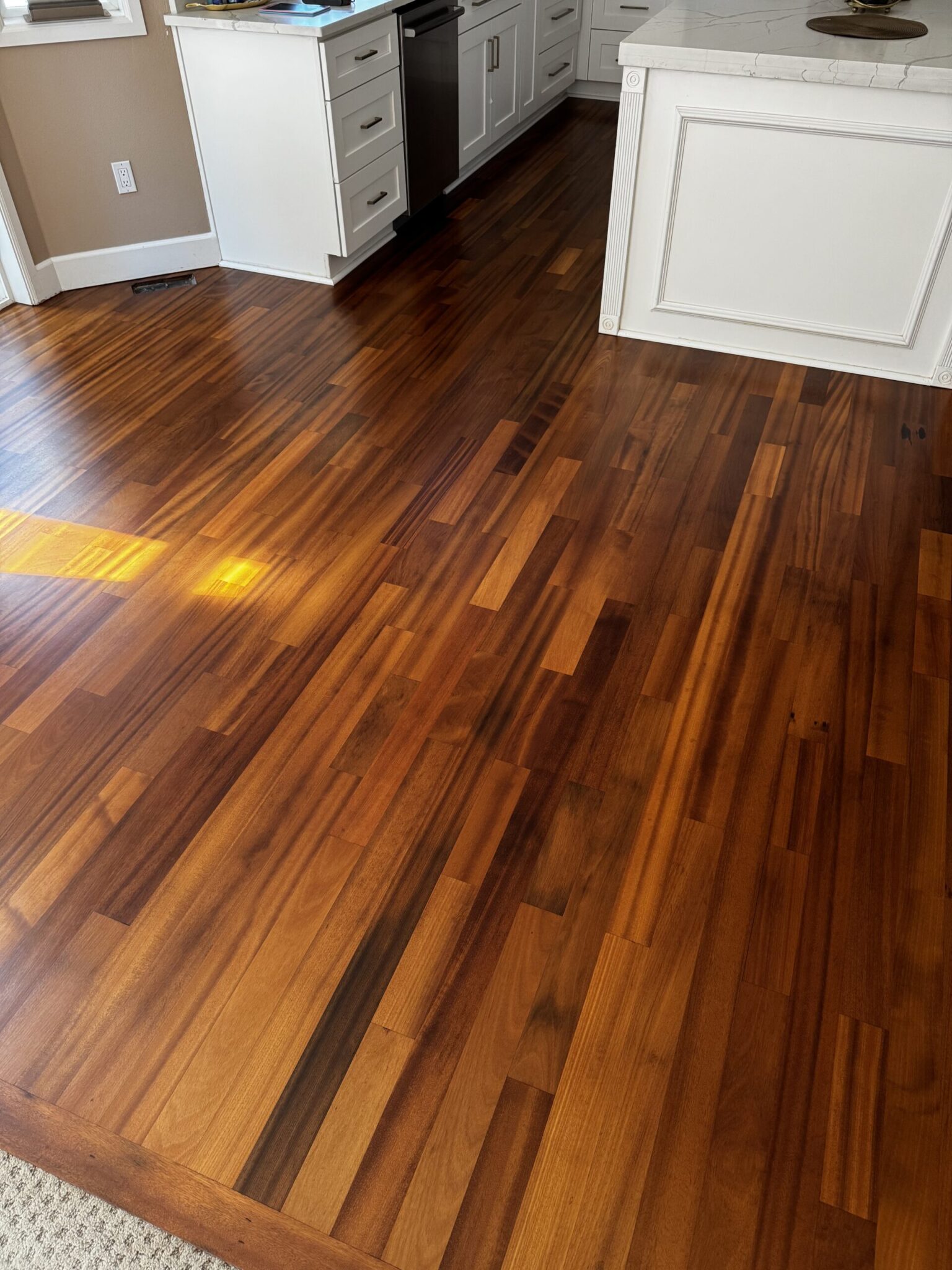 Brazilian cherry hardwood floor refinishing with three coats of oil-based finish by LUKS Construction serving Seattle and Bellevue