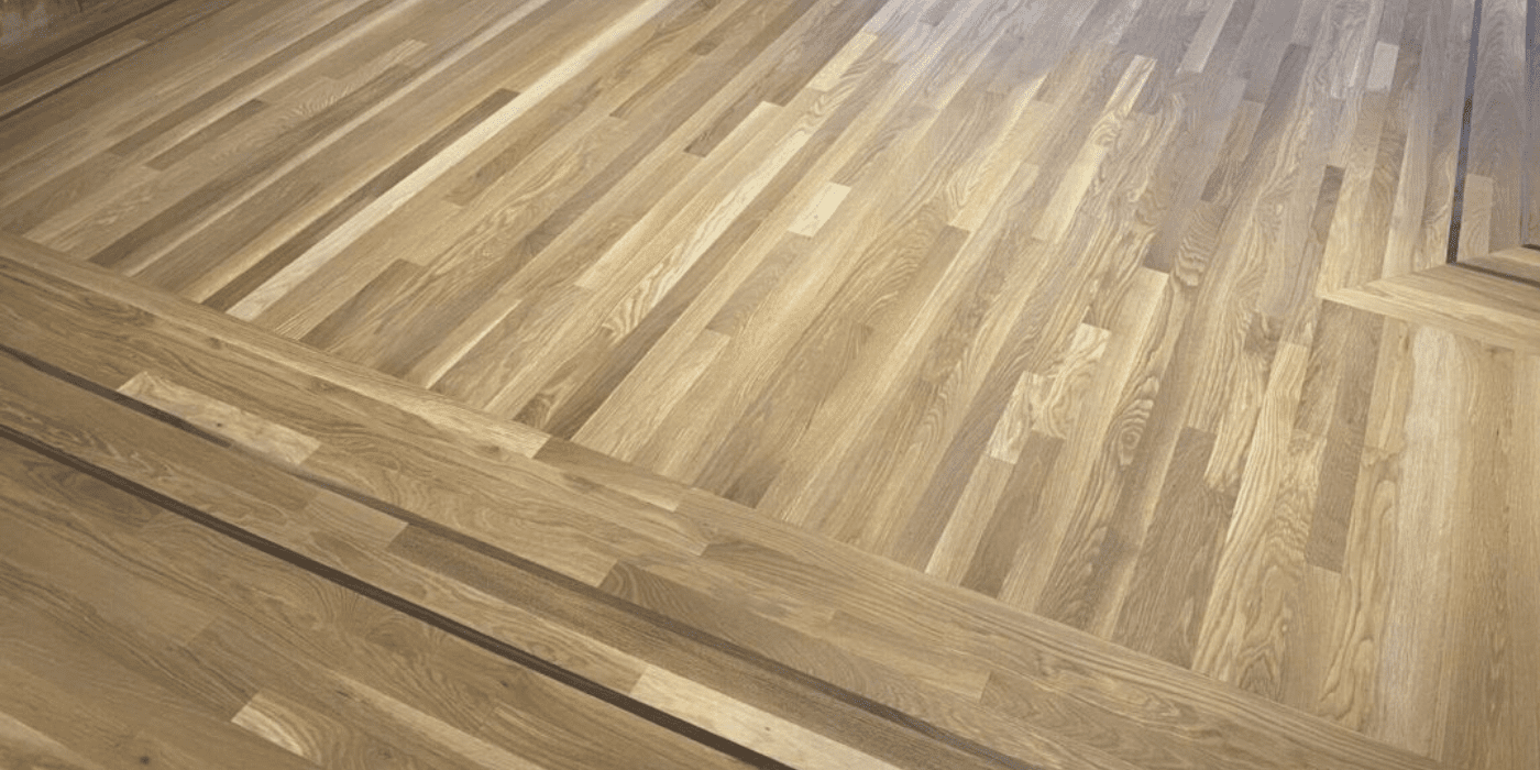 Wide-plank matte hardwood floors in a modern Seattle living room, finished by LUKS Construction for a natural, low-sheen, low-maintenance look.