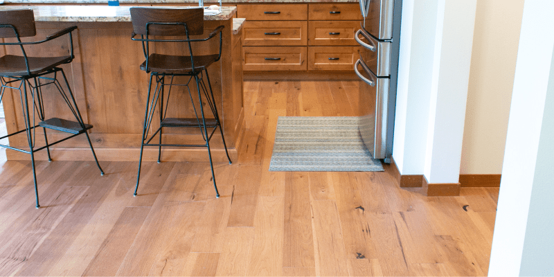 Wide warm hardwood planks sale and installation. Professional hardwood floor installation Eastside home with wide-plank natural wood flooring in Bellevue by LUKS Construction